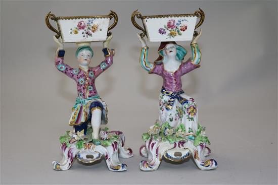 A pair of Bow figural sweetmeat dishes, c.1765-70, height 17cm, restorations